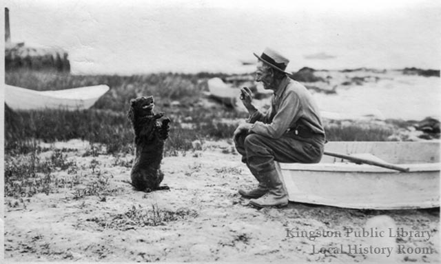 Chester Fuller and his dog near Delanos Wharf, 1890