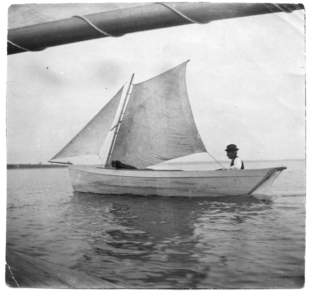 Chester Fuller and dog aboard the 'Chesperus,' 1898