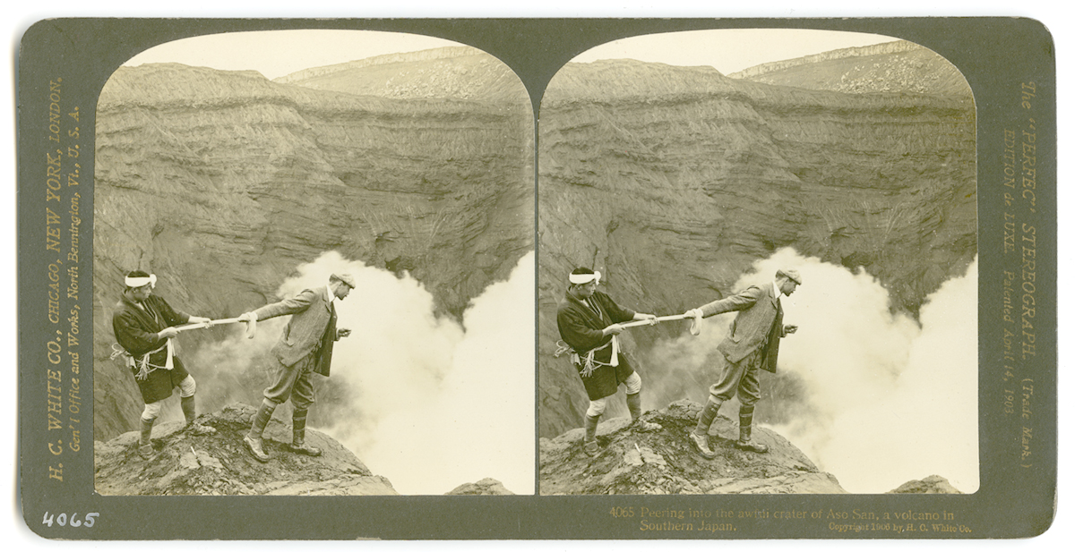 Peering into the awful crater of Aso San, a volcano in Southern Japan, 1906. H.C. White Co.