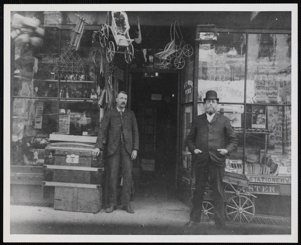 Two men at the entrance of the store at 58-60 Summer Street, circa 1875