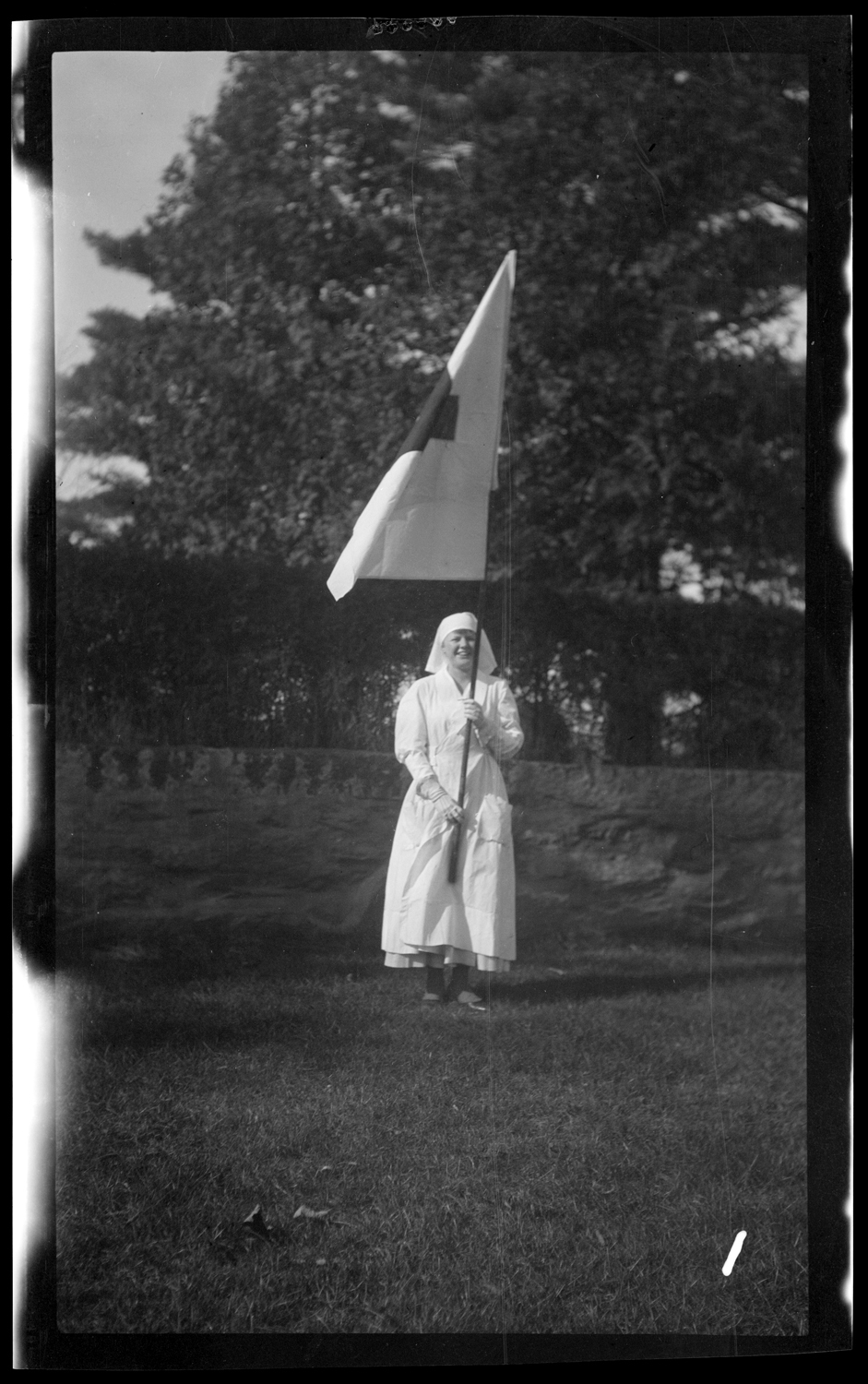 Marcher with Red Cross flag in the Welcome Home parade, October 18, 1919.